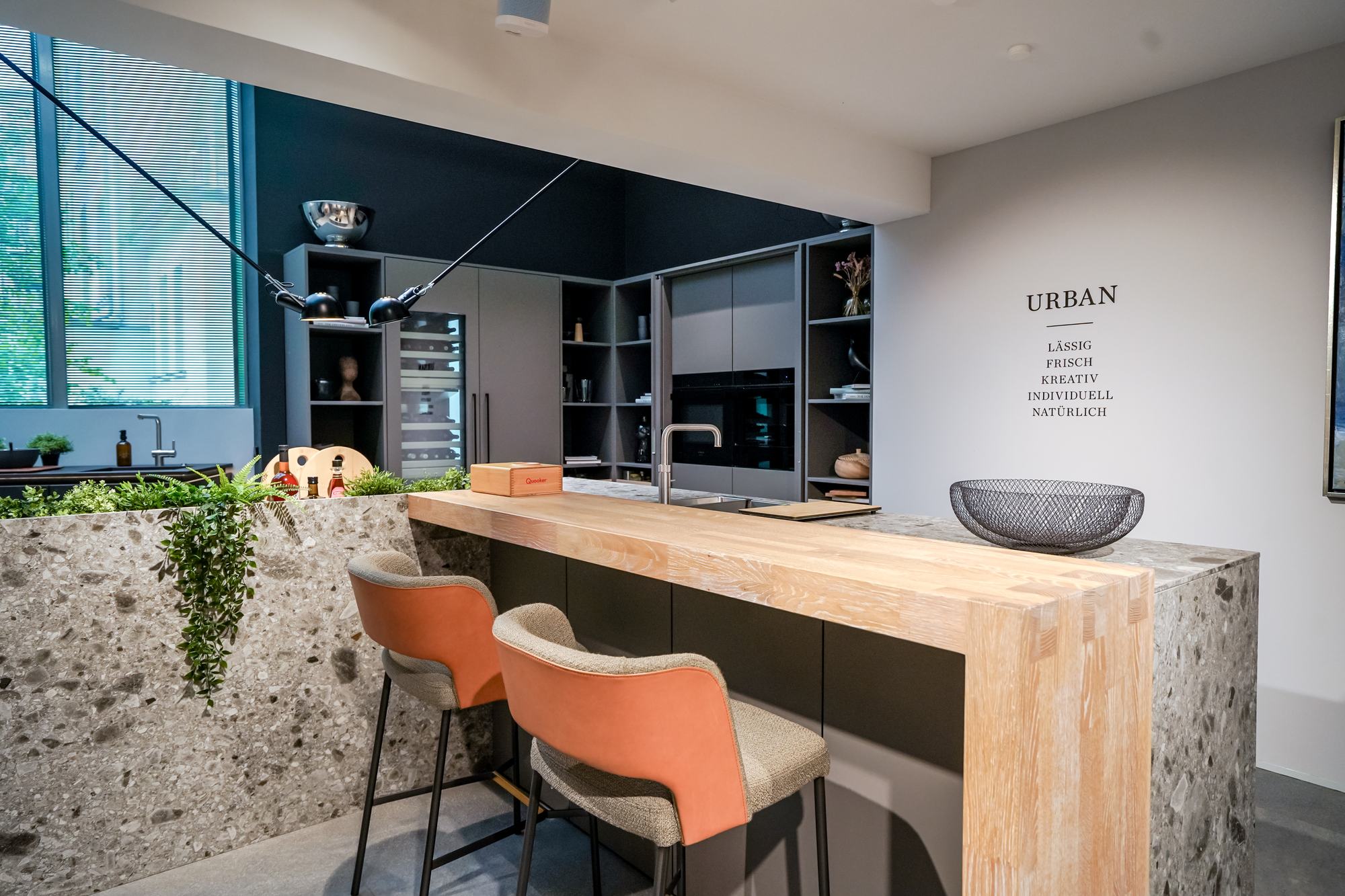 Kücheninsel der Stilwelt URBAN mit Terrazzoplatte und Holztheke im SieMatic Studio Leipzig